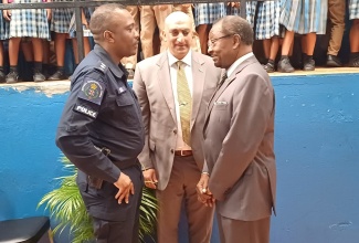 United States Ambassador to Jamaica, His Excellency N. Nickolas Perry (right), speaks  with Country Representative for the United States Agency for International Development (USAID), Dr. Jay Singh (centre) and Acting Assistant Commissioner of Police in charge of Area One, Vernon Ellis, on arrival at the handover ceremony for musical equipment to Flanker Primary School, Montego Bay, St. James, on January 25.

