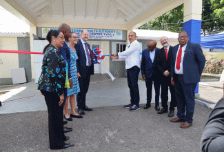 Minister of Health and Wellness, Dr. the Hon. Christopher Tufton (fourth right),  cuts the ribbon to signify the official handover of the upgraded Santa Cruz Health Centre in St. Elizabeth, on January 18.

