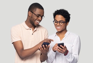 Man showing woman new mobile application on smartphone. 