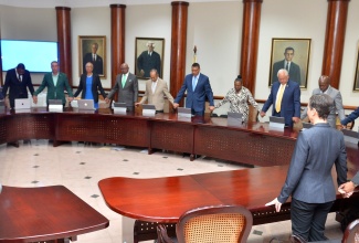 Prime Minister, the Most Hon. Andrew Holness and members of the Cabinet, join hands as they pray with representatives from the Jamaica Umbrella Group of Churches at the Office of the Prime Minister (OPM) on Monday (February 12).


