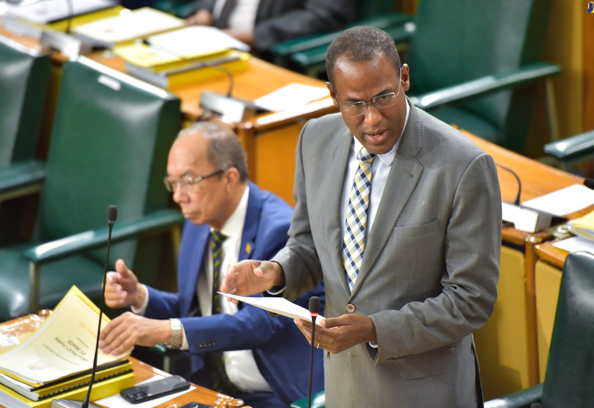 Minister of Finance and the Public Service, Dr. the Hon. Nigel Clarke, tables the 2024/25 Estimates of Expenditure in the House of Representatives on Thursday (February 15). At left is Deputy Prime Minister and Minister of National Security, Hon. Dr. Horace Chang.