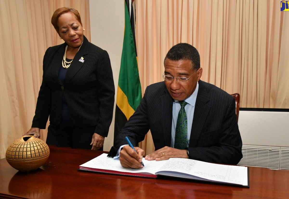 PHOTOS: PM Signs Condolence Book for Late Justice Dennis Morrison