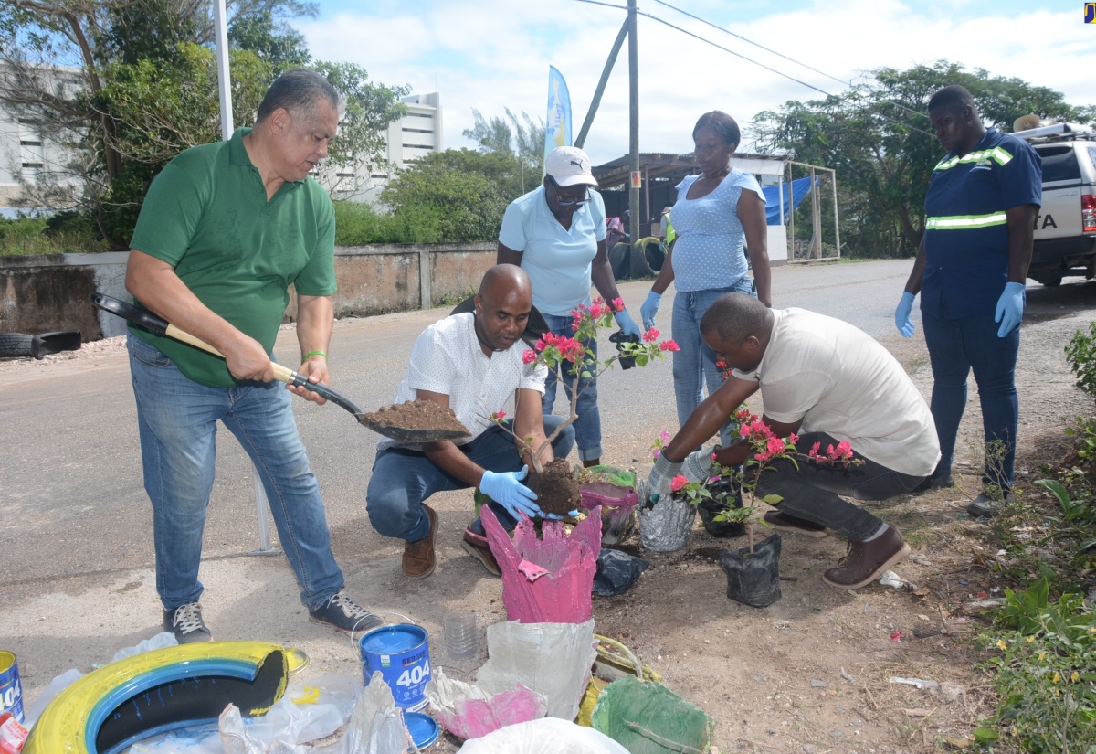 WPM Waste Management Limited team members participate in the repurposing of disposable material into flower pots during Tuesday’s (February 13) ‘For the Love of the Environment Cleanup and Beautification Initiative’ in Cooper's Pen, Trelawny, which was spearheaded by the entity. From left are: Fleet Manager, Lloyd Young; Regional Operations Manager, Edward Muir; Sweepers, Fayann Brown and Tanika Haye; Enforcement Officer, Allistair Black; and Sweeper, Ingrid Barrett