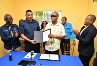 Prime Minister, the Most Hon. Andrew Holness (second left), hands over the New Social Housing Programme contract and keys to beneficiary of the programme, Bertlyn Black (third left) on February 21, at Lancewood in St. Elizabeth. Sharing the moment are (from left) Minister of Local Government and Community Development, Hon. Desmond McKenzie; Councillor for the Brompton Division, Whitney Smith Currie; Mayor of Black River, Councillor Derrick Sangster and Minister of Agriculture, Fisheries and Mining, Hon. Floyd Green.  

