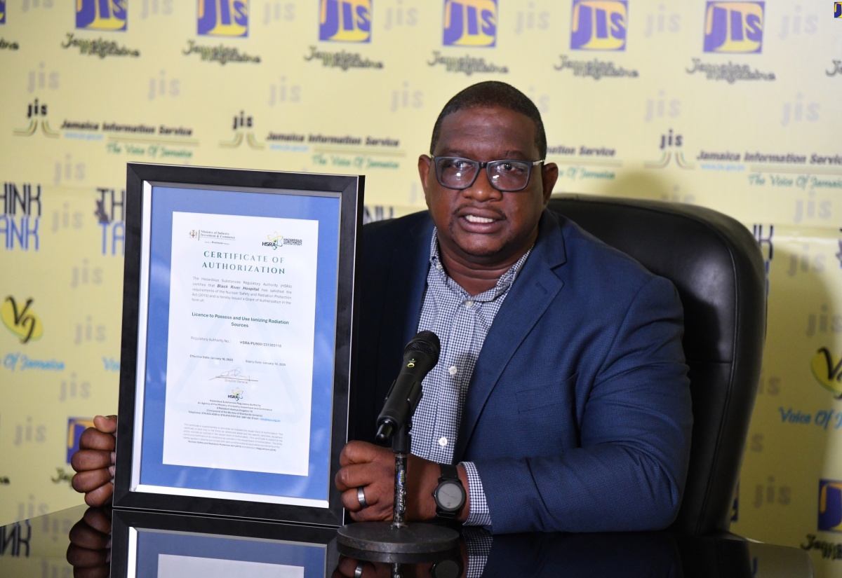 Director General, Hazardous Substances Regulatory Authority (HSRA), Dr. Cliff Riley, displays a copy of the certification of authorisation provided to facilities that use ionising radiation sources in their operations, while speaking during a recent Jamaica Information Service (JIS) ‘Think Tank’ at the Agency’s head office in Kingston.  

