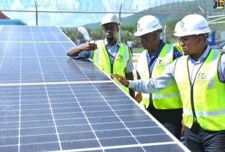 Minister of Agriculture, Fisheries and Mining, Hon. Floyd Green ( right), and State Minister, Hon. Franklin Witter (centre), look at solar panels during the official handover of the Plumwood Pumping Station photovoltaic (PV) solar system in New Forest, Manchester, in June 2023. Highlighting the features is Energy Engineer, National Irrigation Commission (NIC), Emile Mayers. The system was installed under the Rural Economic Development Initiative (REDI-II) and will benefit approximately 1,943 farmers in the New Forest/Duff House Agro-Parks in South Manchester and South St. Elizabeth.

