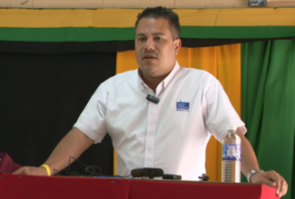 Minister without Portfolio in the Ministry of Economic Growth and Job Creation, Senator the Hon. Matthew Samuda, addresses the recent commissioning ceremony for the Cascade Phase Two Water Supply System Project in Hanover, which was held at Merlene Ottey High School in Pondside in the parish.

