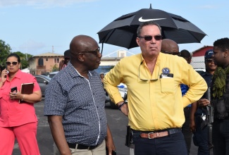 Minister of Science, Energy, Telecommunications and Transport, Hon Daryl Vaz (right), listens to Mayor of Falmouth, Councillor Colin Gager (left), following a tour of the Falmouth Transportation Centre in Trelawny, on January 26.

