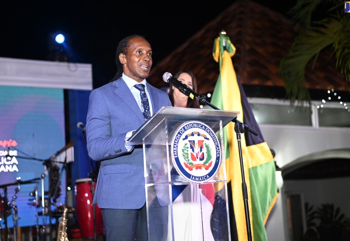 State Minister for Foreign Affairs and Foreign Trade, Hon. Alando Terrelonge, addresses the Dominican Republic’s National Day celebration, while Ambassador of the Dominican Republic to Jamaica, Her Excellency Angie Martinez (in background) looks on. The event was held recently at the Ambassador’s official residence in Kingston.