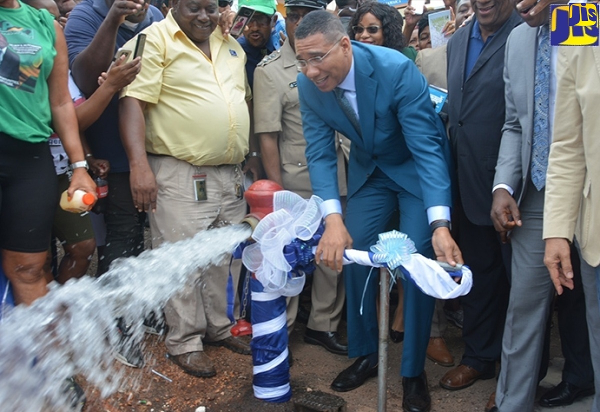 Prime Minister, the Most Hon. Andrew Holness (centre), turns on the main water valve in Junction, St. Elizabeth, to officially commission the Essex Valley Water Supply Project on October 23, 2019.

