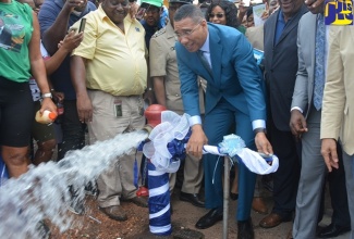 Prime Minister, the Most Hon. Andrew Holness (centre), turns on the main water valve in Junction, St. Elizabeth, to officially commission the Essex Valley Water Supply Project on October 23, 2019.

