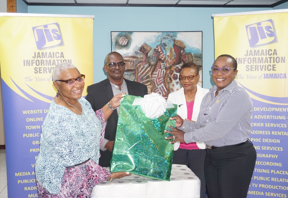 Chief Executive Officer at the Jamaica Information Service (JIS), Enthrose Campbell (second right) and Finance Manager, Glenford West (second left) look on as Company Secretary and Director of Action Chemicals and Equipment, Marva Bernard (left), hands over a package containing sanitation supplies to Board Chairman and Interim Director of Mount Olivet Boys’ Home, Sophia Morgan (right). The presentation was made at the JIS’s offices in Kingston on March 1. The items were provided by Action Chemicals and Equipment, and IJASS Trading Limited, through an initiative of the JIS Finance Department.

