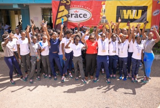 Students and staff of Edwin Allen High School celebrate the institution’s victory in the 2024 ISSA/GraceKennedy Boys and Girls' Athletics Championships at the institution in Frankfield, Clarendon, on Monday (March 25).


