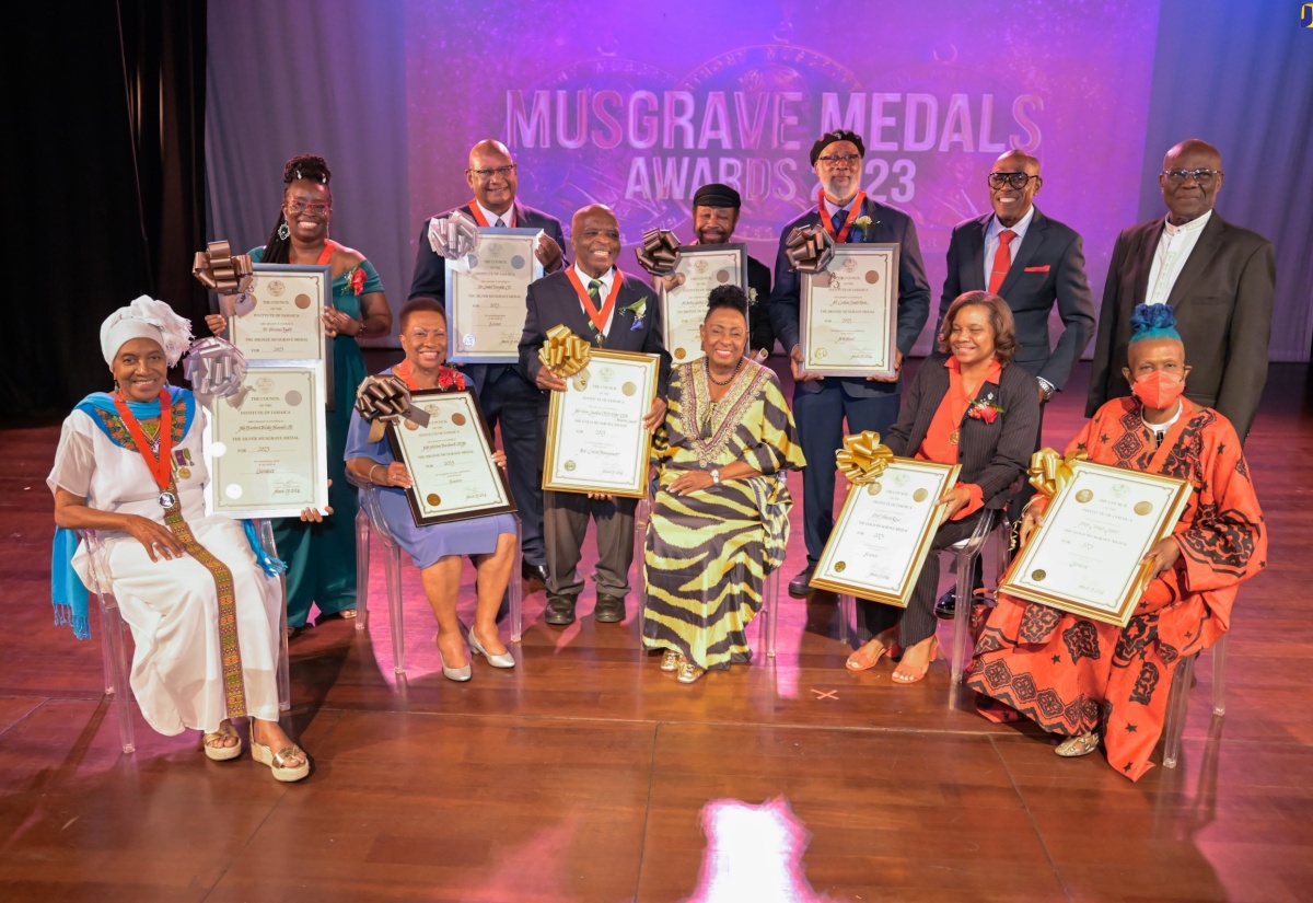 Minister of Culture, Gender, Entertainment and Sport, Hon. Olivia Grange (seated centre), joins the Musgrave Medal Award recipients onstage at the ceremony held on Wednesday (March 27), at the Philip Sherlock Centre for the Creative Arts, University of the West Indies (UWI) Mona, St. Andrew.

