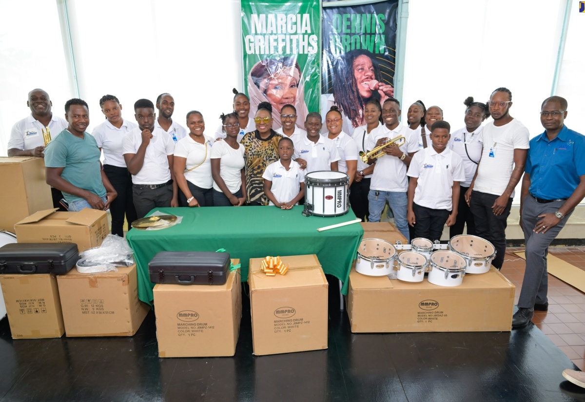 Minister of Culture, Gender, Entertainment and Sport, Hon. Olivia Grange (centre), shares a moment with members of the Trailblazers Marching Band, during a ceremony for the presentation of musical instruments, held at the Ministry’s New Kingston offices on March 28.


