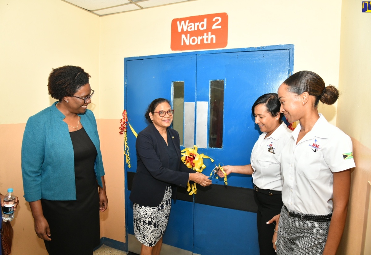 Chief Medical Officer, Dr. Jacquiline Bisasor-McKenzie (second left) cuts the ribbon to officially open the newly renovated Ward 2 North at the Kingston Public Hospital (KPH) to Tuesday (March 26). Looking on (from left) are Acting Chief Executive Officer at KPH, Dr. Natalie Whylie; Chief Executive Officer (CEO), D.M. Equipment Company Limited/Zoukie Trucking Services Limited, Michelle Henry; and Project Manager at the company, Joshelle Campbell.

