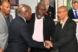 Minister of Labour and Social Security, Hon. Pearnel Charles Jr. (second left), greets President of the Caribbean Congress of Labour, André Lewis (right), during a courtesy call at the Ministry’s North Street offices in Kingston on Wednesday (March 6). Others (from left) are President, Jamaica Confederation of Trade Unions (JCTU), St. Patrice Ennis and Vice President, Bustamante Industrial Trade Union (BITU), Rudolph Thomas.

