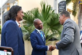 Prime Minister, the Most Hon. Andrew Holness (right), greets University of Technology (UTech) President, Dr. Kevin Brown, during the launch of the Amber UTech Launchpad at the institution’s campus in Papine, St. Andrew on Wednesday (March 6). Looking on are Founder and Chief Executive Officer, Amber Group, Ambassador Dushyant Savadia, and UTech Pro Chancellor, Aldrick McNab (partly hidden).

