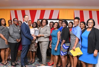 Motivational Speaker, Jeffery Azan (third left) makes a presentation to Chief Audit Executive at the Ministry of Education and Youth, Audrey Gentles-McCallum (fifth right) at the Ministry of Finance and the Public Service Internal Auditors’ symposium held on February 29 at The Summit in Kingston recently.