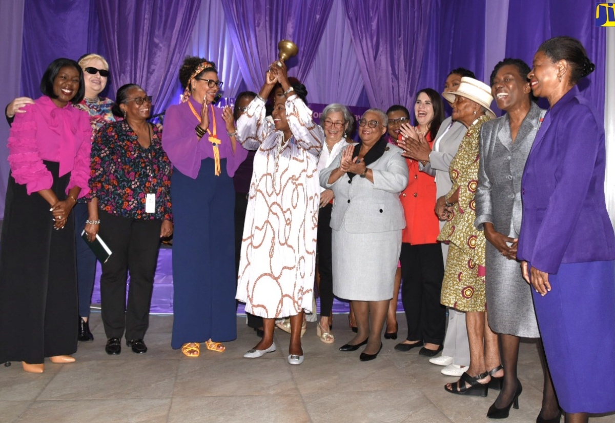 Minister of Culture, Gender, Entertainment and Sport, Hon. Olivia Grange (centre) rings the bell for gender equality, at the Jamaica Stock Exchange (JSE), International Women's Day Bell Ringing Ceremony, held on March 8 at the JSE Multipurpose Centre in Kingston.

 