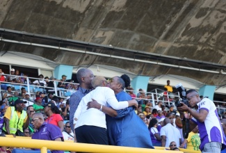 Minister of Culture, Gender, Entertainment and Sport, Hon. Olivia Grange (right), and Minister of Education and Youth, Hon. Fayval Williams, embrace in greeting on the final day of the ISSA/GraceKennedy Boys and Girls Championship 2024, at the National Stadium in Kingston on Saturday, March 23.