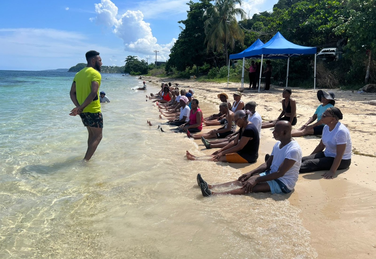 Regional Physical Activity Specialist, Western Regional Health Authority (WRHA), Orane Gardner, leads a beach exercise session with the Hopewell Senior Citizens Support Group in Hanover.

