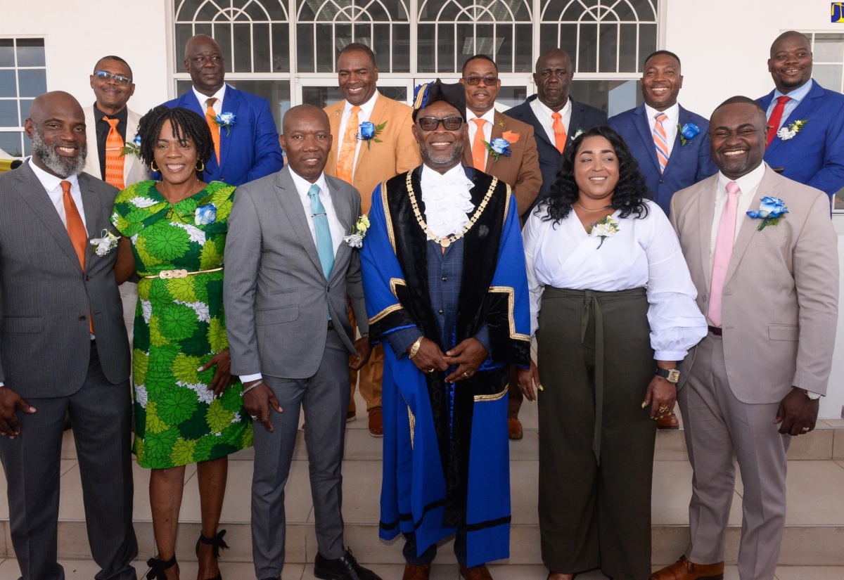 Mayor of Portmore, His Worship Leon Thomas (third right, front row), is surrounded by newly installed Councillors of the Portmore Municipal Corporation during the swearing-in ceremony at Lot 1 Cookson Pen, Braeton Parkway, Greater Portmore, on March 12.

