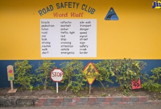 A section of the August Town Primary School's Road Safety Garden, featuring the Road Safety Word Wall and handcrafted road signs.


