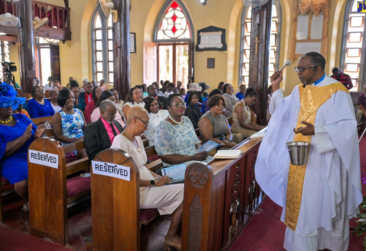 Minister of Education and Youth, Hon. Fayval Williams (seated left) is sprinkled with holy water by Rector, Mandeville Parish Church, Rev. Michael Elliott at the Jamaica Teachers’ Association’s 60th Anniversary Church Service held at the church in Manchester today (March 31).

 