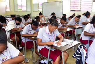 Grades 12 and 13 students at St. Andrew High School for Girls sit the road code test, which was administered by the Island Traffic Authority (ITA) at the school’s Cecelio Avenue address in St. Andrew on Tuesday (April 23).