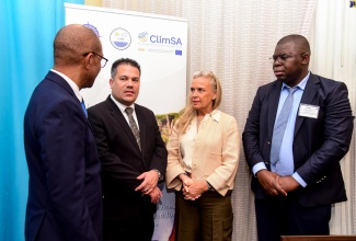 Minister without Portfolio in the Ministry of Economic Growth and Job Creation, Senator the Hon. Matthew Samuda (second left), in discussion with (from left) Principal Director, Meteorological Service of Jamaica, Evan Thompson; Ambassador, European Union to Jamaica, Her Excellency Marianne Van Steen; and Head, Regional Climate Prediction Services, World Meteorological Organization, Wilfran Moufouma-Okia, during the opening ceremony for the Jamaica National Stakeholder Consultation on Climate Services and the 1st National Climate Forum (NCF-1), at the Courtyard by Marriott Hotel in New Kingston on Monday (April 29).

