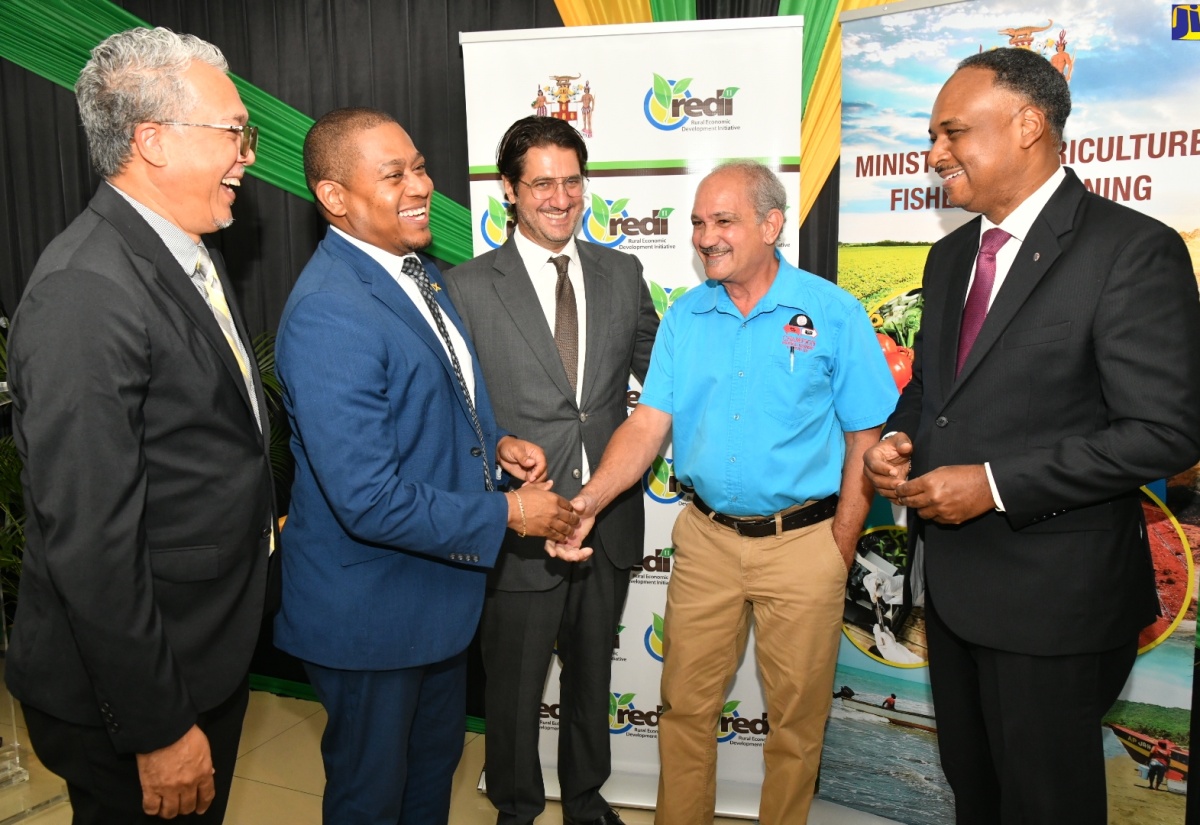 Minister of Agriculture, Fisheries and Mining, Hon. Floyd Green (second left), engages in a light discussion with Director of Projects, Champion Industrial Equipment and Supplies Limited, Courtney Harford (second right), during the $106-million contract signing ceremony for the Agro-Investment Corporation Irrigation Transmission Force Main and Equipping Project, at Ebony Park, Clarendon, at the Ministry’s Hope Gardens offices in St. Andrew, on April 11.  Others (from left) are Chief Executive Officer, Agro-Investment Corporation, Vivion Scully; Programme Lead, The World Bank Group, Emre Ozaltin and Managing Director, Jamaica Social Investment Fund (JSIF), Omar Sweeney.