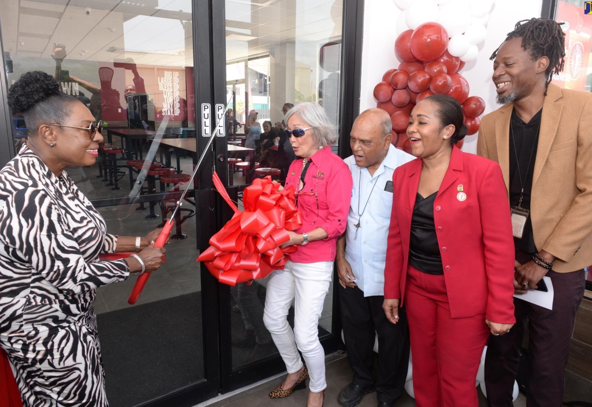 Minister of Culture, Gender, Entertainment and Sport and Member of Parliament for St. Catherine Central, Hon. Olivia Grange (left), cuts the ribbon to officially open Island Grill’s New Brunswick Village restaurant in Spanish Town on Wednesday (April 10). Celebrating the moment are (from second left)  Founder and Deputy Chairman of Island Grill, Thalia Lyn; Monsignor Gregory Ramkissoon; Chief Executive Officer of Island Grill, Tania Waldron-Gordon, and Councillor for the Spanish Town Division, Christopher Shackleford.

