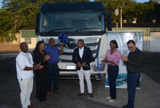 Minister of Agriculture, Fisheries and Mining, Hon. Floyd Green (third right), commissions a new 5,000-gallon water truck into service at the Lydford Industrial Park in St. Ann on Friday (April 19), which will benefit farmers in the parish. He is joined by (from left) Parish Agricultural Manager for the Rural Agricultural Development Authority (RADA) in St. Ann, Delroy Luke; Jamaica Bauxite Mining Limited (JBM) Managing Director, Donna Marie Howe; Minister of State in the Ministry of Agriculture, Fisheries and Mining, Hon. Franklin Witter;  Director on JBM Board of Directors, Michelle Campbell Sawyer; and Vice Chairman of the JBM Board of Directors, Robert Chung.

