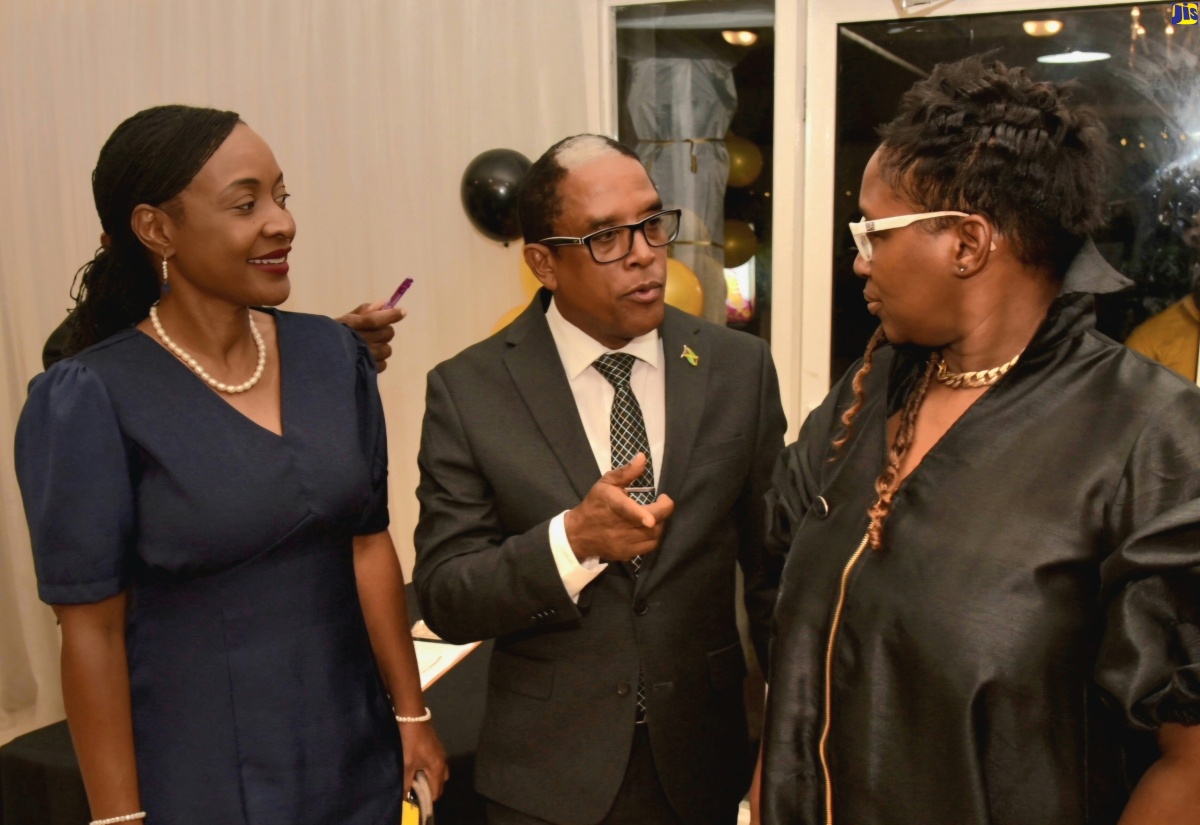 Minister of State in the Ministry of Labour and Social Security, Dr. the Hon. Norman Dunn (centre), makes a point to Chief Executive Officer of Stationery World & Book Centre Limited, Joy Scott (right), during the entity’s 21st anniversary celebrations, held at the Terra Nova All-Suite Hotel in St. Andrew on Wednesday (April 10). Sharing in the conversation is State Minister in the Ministry of Education and Youth, Hon. Marsha Smith. 