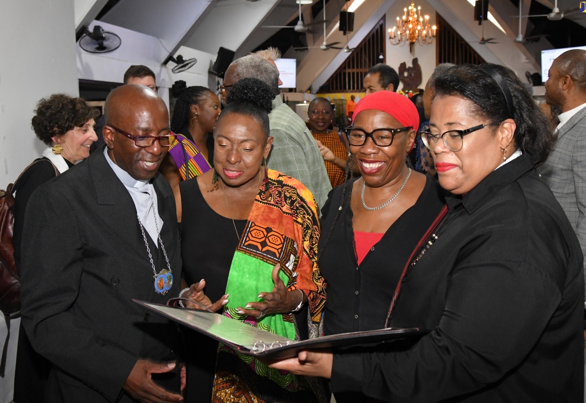 Culture, Gender, Entertainment and Sport Minister, Hon. Olivia Grange (second left), looks at the apology from the United Reformed Church (URC), United Kingdom (UK) for the institution’s involvement in slavery, which was handed over by Moderator of the Assembly of the URC, Reverend Dr. Tessa Henry-Robinson (right). Sharing the moment are Moderator of the United Church in Jamaica and the Cayman Islands, Rev. Gary Harriott (left) and Secretary for Global Intercultural Ministries, URC, Karen Campbell. Occasion was an ecumenical church service on ‘Reparation, A Path to Repentance, Healing, and Unity’, held on Sunday (April 14) at the Webster Memorial United Church in St. Andrew.

