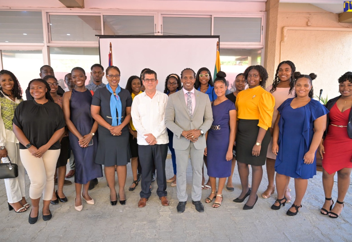 Minister of State in the Ministry of Foreign Affairs and Foreign Trade, Hon. Alando Terrelonge (centre, front row);  Cuban Ambassador to Jamaica, His Excellency Fermín Quiñones (fourth left), and Permanent Secretary in the Ministry, Ambassador Sheila Sealy Monteith (third left), with the 15 Jamaican students who have gained scholarships to study in the Republic of Cuba, during a ceremony held at the Embassy of Cuba, in St. Andrew, on April 24.