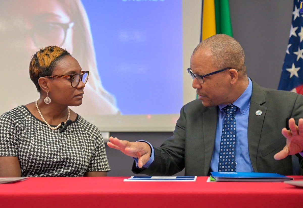 Minister of State in the Ministry of National Security, Hon. Juliet Cuthbert-Flynn, in discussion with Senior Policy Advisor, United Nations Regional Centre for Peace, Disarmament and Development in Latin America and the Caribbean (UNLIREC), Jason Francis, during Tuesday’s (April 16) opening ceremony for the firearms marking workshop at the Institute of Forensic Science and Legal Medicine offices in St. Andrew.

