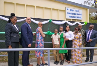 Minister of Education and Youth, Hon. Fayval Williams (third left), cuts the ribbon to officially hand over the Special Education Unit at the Hope Valley Experimental School in St. Andrew on Thursday (April 18). Joining her (from left) are Education Officer in the Ministry’s Special Education Unit, Christina Addington; Country Representative, United States Agency for International Development (USAID), Dr. Jaidev Singh; students Jehue Mullings and Ashley Holland; Chief Executive Officer of the Digicel Foundation, Charmaine Daniels; Parent-Teacher Association (PTA) President, Hope Valley Experimental, Georgette McGlashen-Miller; Board Chairman of the school, Noel Osbourne; and Principal, Anthony Grant.


