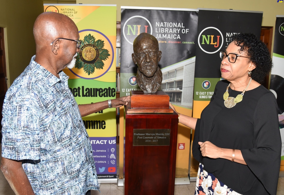 Professor Mervyn Morris (left) and Chair, Board of Management, National Library of Jamaica, Joy Douglas (right) view the honorary bust of the former Poet Laureate of Jamaica, following the unveiling ceremony held at the National Library of Jamaica in Kingston on Sunday (April 21).