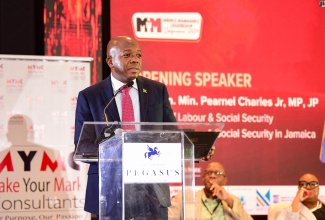 Minister of Labour and Social Security, Hon. Pearnel Charles Jr., addresses Make Your Mark Group’s Middle Managers' Leadership Conference 2024 at The Jamaica Pegasus hotel in New Kingston on May 1.

