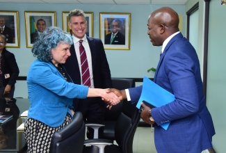Minister of Labour and Social Security, Hon. Pearnel Charles Jr. (right), greets Head of Programme, World Food Programme Caribbean Multi-Country Office, Sarah Bailey (left) during a courtesy call at the Ministry’s 1F North Street offices in Kingston on May 2. Looking on is Head of World Food Programme Office (Jamaica), Dana Sacchatti.