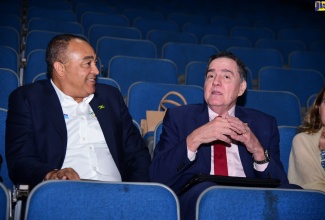 Minister of Health and Wellness, Dr. the Hon. Christopher Tufton (left), engages in light conversation with Director of the Pan American Health Organization (PAHO) and World Health Organization (WHO) Regional Director for the Americas, Dr. Jarbas Barbosa da Silva Jr. The occasion was the screening of a 30-minute documentary titled ‘Dying Young: Lifestyle Choices and the NCD Crisis’, highlighting the impact of non-communicable diseases (NCDs), at Courtleigh Auditorium in Kingston on Wednesday (May 8).

