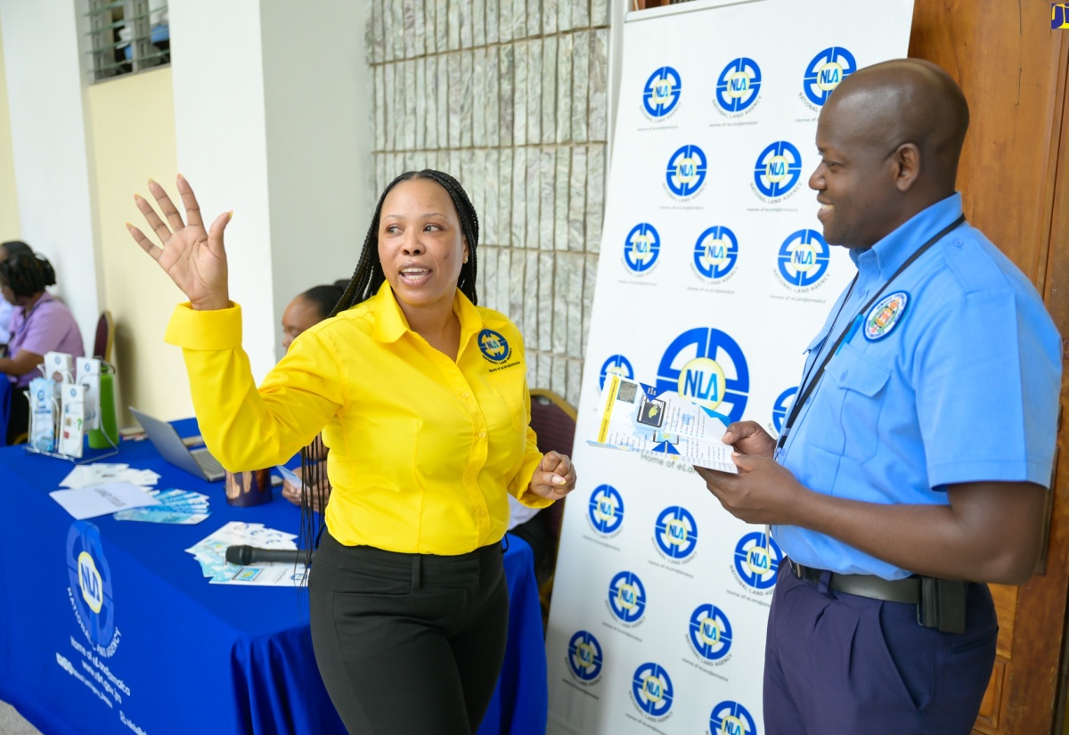 Marketing and Public Relations Officer at the National Land Agency (NLA), Nicole Hayles, engages with Jamaica Constabulary Force (JCF) Officer, Dwite Thomas, during the NLA’s Government Employees Mobile Land Information Clinic at the Office of the Prime Minister (OPM) in Kingston on Wednesday (May 1). The NLA is hosting a series of information sessions for government workers from May 2024 to March 2025 to address their land-related queries.

