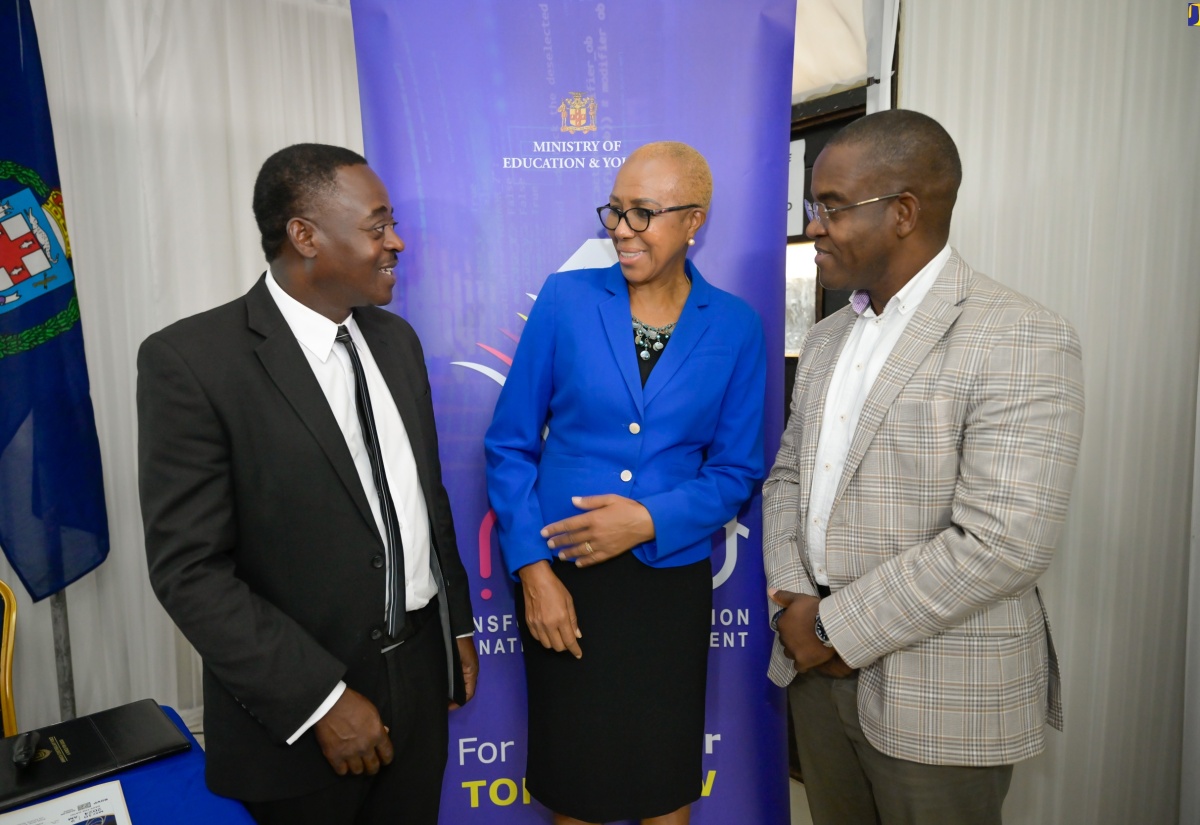 Minister of Education and Youth, Hon. Fayval Williams (centre) engages in conversation with Chairman of the National Child Online Protection Committee (N-COPC), Carl Berry (left) and Commissioner of Police, Dr. Kevin Blake (right), at N-COPC’s open house activity at the Police Officer’s Club in St. Andrew on Friday (May 10). The committee provides children with tools for online safety. The open house was held under the theme ‘Developing Strategies and Responses to Enable Comprehensive Protection of the Nation’s Children on- and offline’.