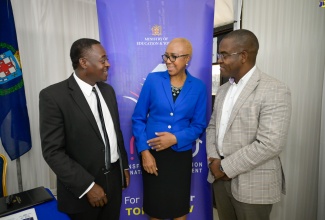 Minister of Education and Youth, Hon. Fayval Williams (centre) engages in conversation with Chairman of the National Child Online Protection Committee (N-COPC), Carl Berry (left) and Commissioner of Police, Dr. Kevin Blake (right), at N-COPC’s open house activity at the Police Officer’s Club in St. Andrew on Friday (May 10). The committee provides children with tools for online safety. The open house was held under the theme ‘Developing Strategies and Responses to Enable Comprehensive Protection of the Nation’s Children on- and offline’.