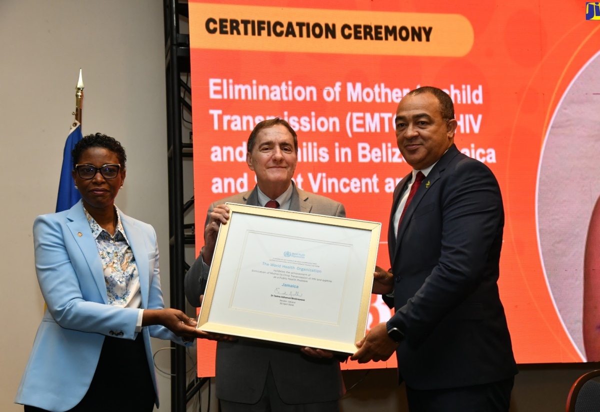 Health and Wellness Minister, Dr. the Hon. Christopher Tufton (right), is presented with a certificate for the Elimination of mother-to-child transmission (EMTCT) of HIV and Syphilis in Jamaica, by Pan American Health Organization (PAHO) Director, Dr Jabas Barbosa (centre), and Assistant Director, Dr Rhonda Sealy-Thomas. Belize, and St. Vincent and the Grenadines also received certification at the ceremony held on Tuesday (May 7) at The Jamaica Pegasus hotel in St. Andrew.

