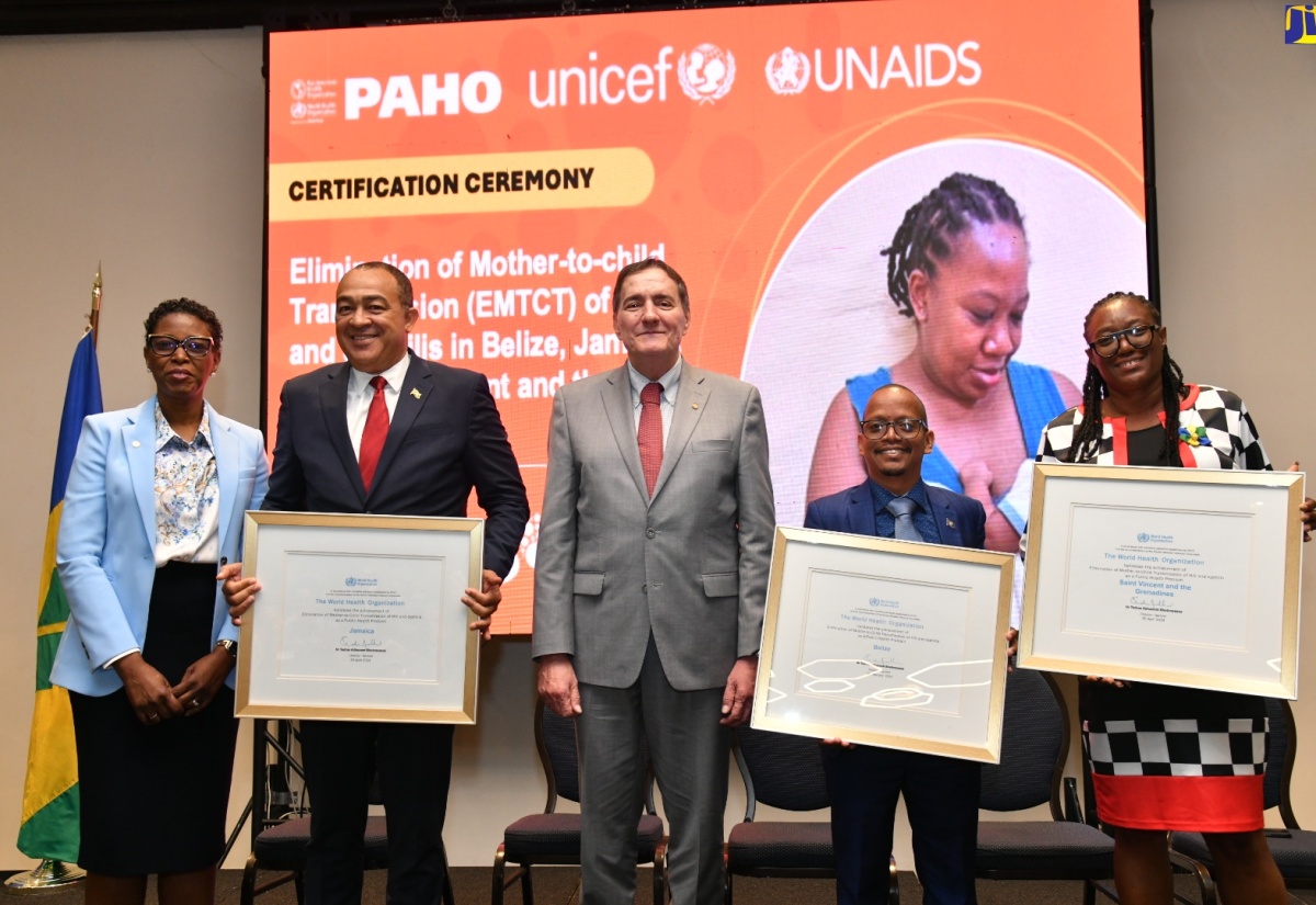 Health and Wellness Minister, Dr. the Hon. Christopher Tufton (second left);  Minister of Health and Wellness for Belize, Kevin Bernard (second right); and Representative from the Ministry of Health and Wellness in St. Vincent and the Grenadines, Arlitha John Douglas (right), display World Health Organization (WHO) certification for the Elimination of mother-to-child transmission (EMTCT) of HIV and Syphilis in their countries. Sharing the moment are Pan American Health Organization (PAHO) Director, Dr. Jabas Barbosa (centre), and Assistant Director, Dr Rhonda Sealy-Thomas. The certification ceremony was held on Tuesday (May 7) at The Jamaica Pegasus hotel in St. Andrew.

