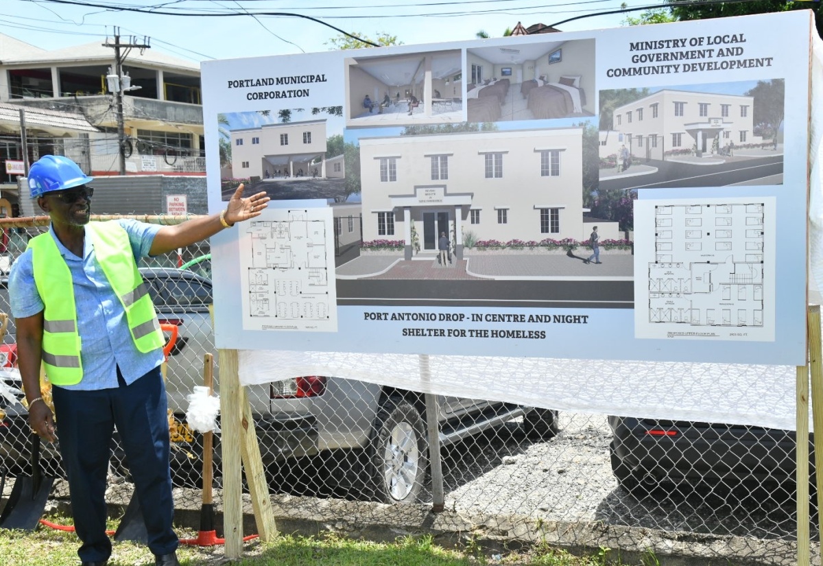 Minister of Local Government and Community Development, Hon. Desmond McKenzie displays plans for the Portland Night Shelter and Drop-in Centre, during the groundbreaking ceremony held on May 10 at the Poor Relief Office in Port Antonio.

