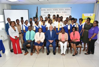 Minister of Justice, Hon. Delroy Chuck (seated, centre) and Chief Technical Director in the Ministry, Kayla Sewell Mills (seated, second left), as well as other members of staff from the Ministry, with more than 20 high-school students from Waterford High School in Portmore, St. Catherine, who took part in discussions about alternative justice services, during National Children’s Day (May 17), a Child Month event, held at the Ministry’s offices in Kingston.

